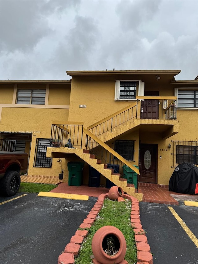 3434 SW 112th Ave Unit 3-2, Miami, FL 33165 - rear view of property with stucco siding, uncovered parking, and stairway