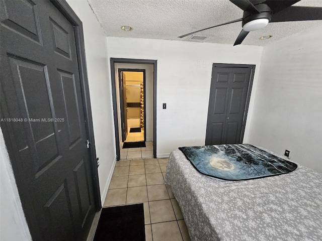 3434 SW 112th Ave Unit 3-2, Miami, FL 33165 - bedroom with light tile patterned floors, a textured ceiling, a closet, a ceiling fan, and baseboards