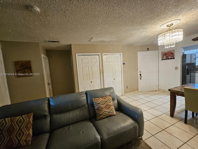 3434 SW 112th Ave Unit 3-2, Miami, FL 33165 - living area with light tile patterned flooring, a chandelier, and a textured ceiling