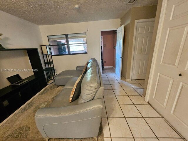 3434 SW 112th Ave Unit 3-2, Miami, FL 33165 - living area featuring a textured ceiling and light tile patterned flooring