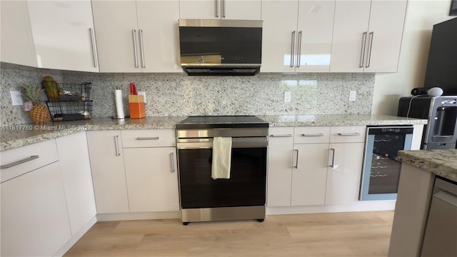 4221 Laurel Ridge Cir, Weston, FL 33331 - kitchen featuring appliances with stainless steel finishes, beverage cooler, light wood finished floors, and backsplash