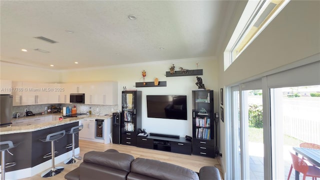 4221 Laurel Ridge Cir, Weston, FL 33331 - living area featuring crown molding and light wood-style flooring