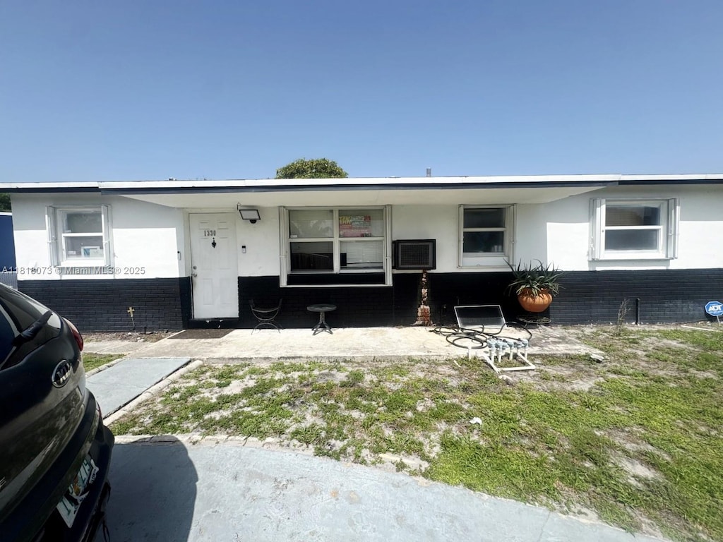 1330 SW 6th Ter, Deerfield Beach, FL 33441 - view of front of home with stucco siding, brick siding, and covered porch