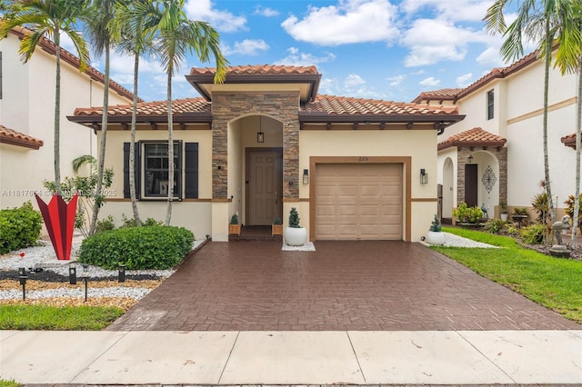 685 SE 34th Ter, Homestead, FL 33033 - mediterranean / spanish home featuring stucco siding, decorative driveway, a garage, and a tile roof