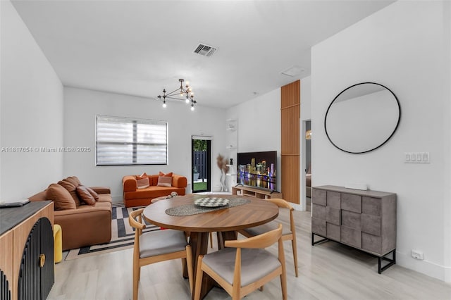 685 SE 34th Ter, Homestead, FL 33033 - dining area with a chandelier and light wood finished floors