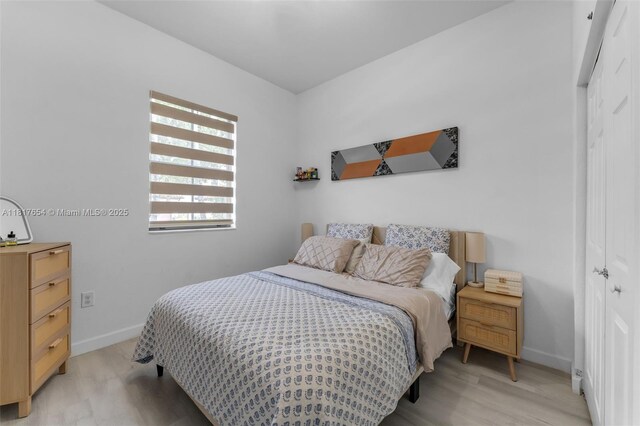 685 SE 34th Ter, Homestead, FL 33033 - bedroom featuring a closet, light wood-style floors, and baseboards