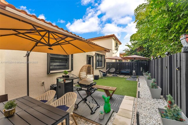 685 SE 34th Ter, Homestead, FL 33033 - fenced backyard with outdoor dining space and a patio