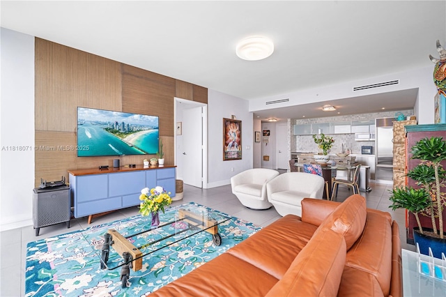1040 Biscayne Blvd Unit 3607, Miami, FL 33132 - living room featuring tile patterned flooring, baseboards, and an accent wall