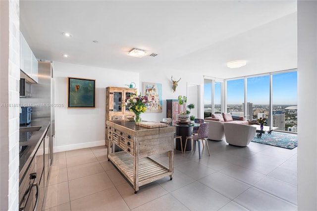 1040 Biscayne Blvd Unit 3607, Miami, FL 33132 - kitchen featuring white cabinetry, baseboards, a wall of windows, light tile patterned floors, and recessed lighting