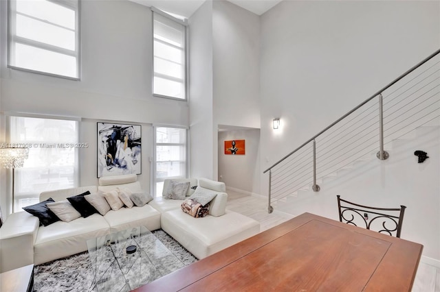 2730 NE 183rd St Unit Th03, Aventura, FL 33160 - living room featuring a high ceiling, stairway, and baseboards