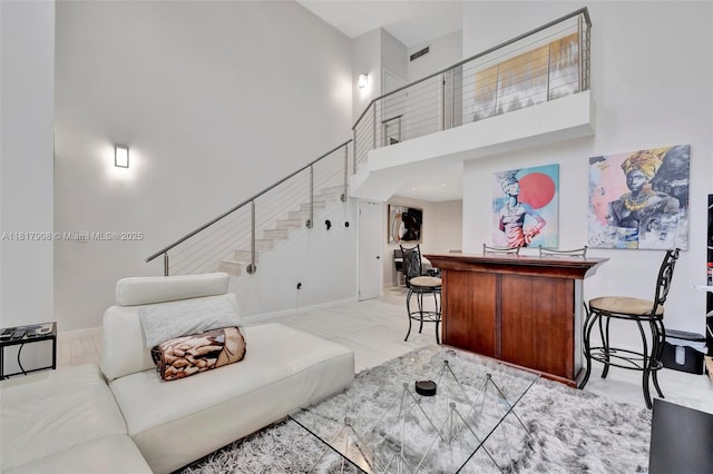2730 NE 183rd St Unit Th03, Aventura, FL 33160 - living room with a high ceiling, stairs, a dry bar, and baseboards