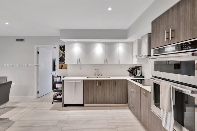 2730 NE 183rd St Unit Th03, Aventura, FL 33160 - kitchen featuring stainless steel appliances, a sink, wall chimney range hood, light countertops, and modern cabinets