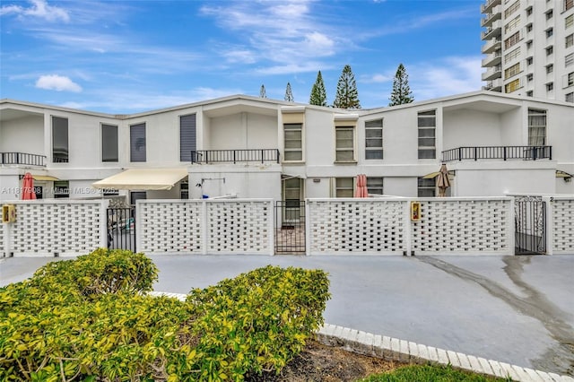 2730 NE 183rd St Unit Th03, Aventura, FL 33160 - view of front of house featuring stucco siding and a gate