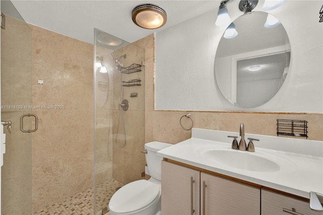 5665 W 20th Ave Unit 415, Hialeah, FL 33012 - bathroom featuring toilet, a shower stall, vanity, and tile walls