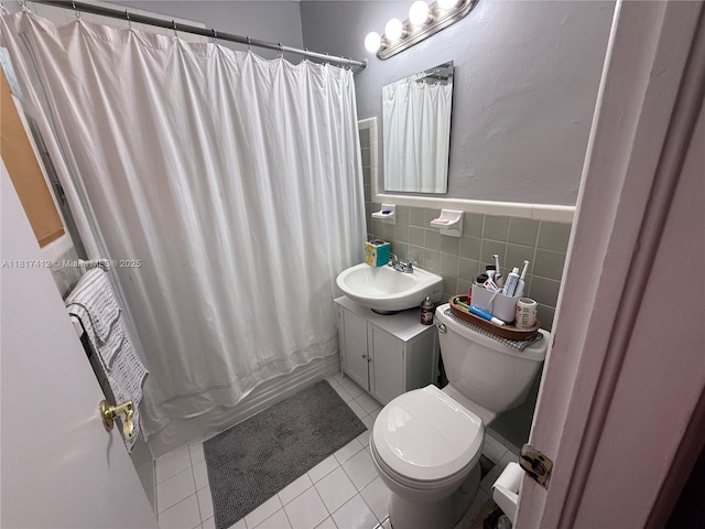 7840 SW 55th Ave Unit 23C, Miami, FL 33143 - bathroom featuring tile patterned floors, shower / bathtub combination with curtain, vanity, tile walls, and wainscoting