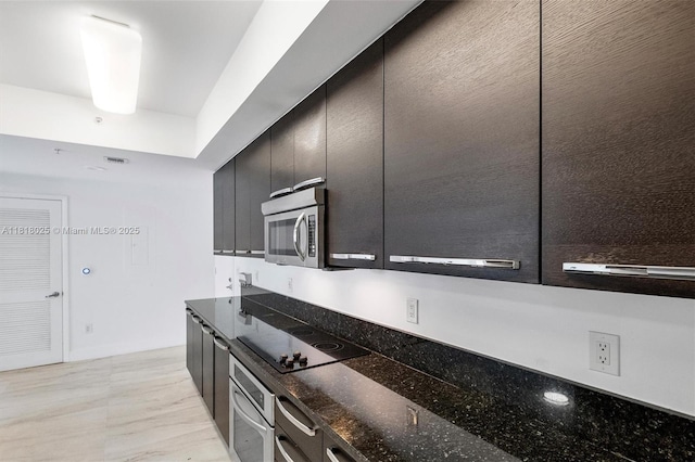 3030 NE 188th St Unit 609, Aventura, FL 33180 - kitchen with appliances with stainless steel finishes, dark cabinets, and dark stone counters