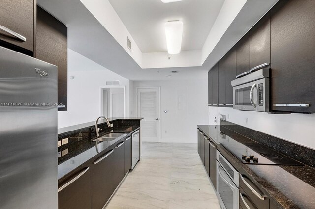 3030 NE 188th St Unit 609, Aventura, FL 33180 - kitchen with a sink, appliances with stainless steel finishes, light marble finish floors, and dark stone counters