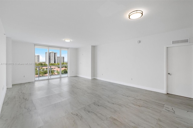 3030 NE 188th St Unit 609, Aventura, FL 33180 - unfurnished room with marble finish floors, a wall of windows, a view of city, and baseboards