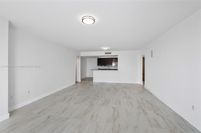 3030 NE 188th St Unit 609, Aventura, FL 33180 - unfurnished living room featuring baseboards