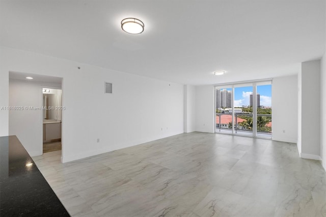 3030 NE 188th St Unit 609, Aventura, FL 33180 - unfurnished room with expansive windows, a city view, and baseboards