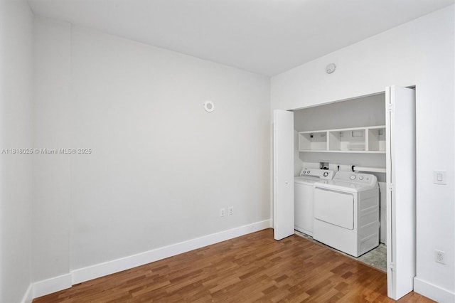 3030 NE 188th St Unit 609, Aventura, FL 33180 - laundry area with washing machine and clothes dryer, light wood-type flooring, and baseboards