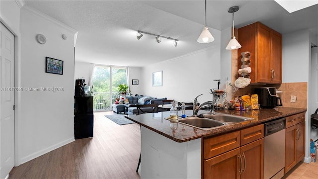 2000 N Bayshore Dr Unit 218, Miami, FL 33137 - kitchen with dishwasher, a sink, brown cabinetry, open floor plan, and light wood-style floors