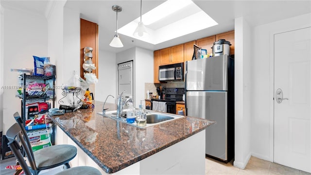 2000 N Bayshore Dr Unit 218, Miami, FL 33137 - kitchen with appliances with stainless steel finishes, a peninsula, a sink, baseboards, and hanging light fixtures