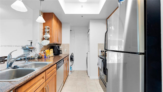 2000 N Bayshore Dr Unit 218, Miami, FL 33137 - kitchen with appliances with stainless steel finishes, a sink, brown cabinetry, and light tile patterned floors