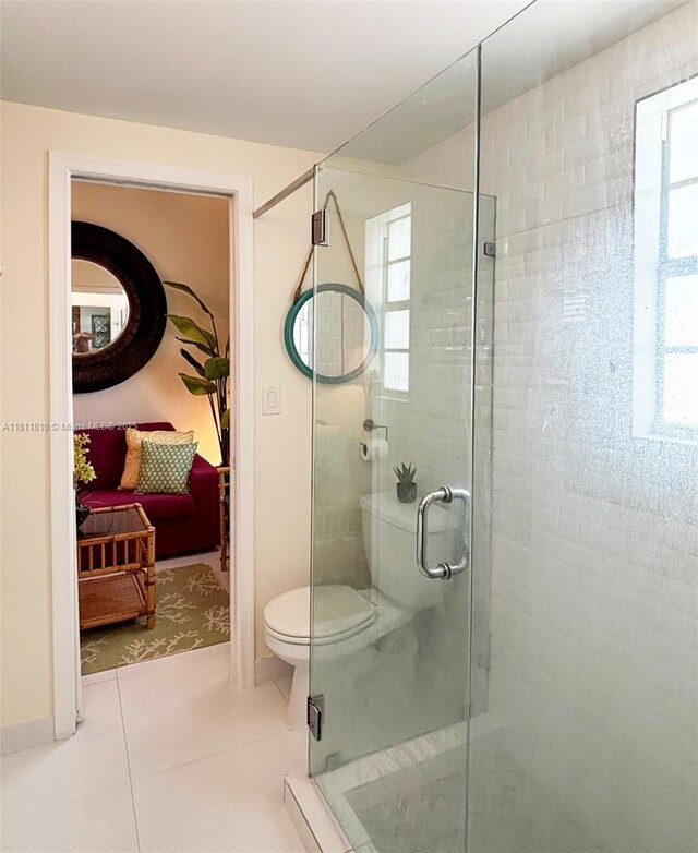 335 Ocean Dr Unit 114, Miami Beach, FL 33139 - bathroom with toilet, a stall shower, and tile patterned flooring