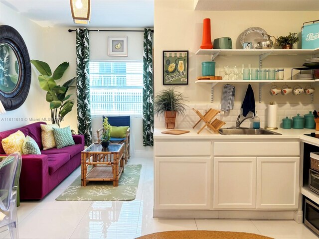 335 Ocean Dr Unit 114, Miami Beach, FL 33139 - living room with light tile patterned flooring and bar