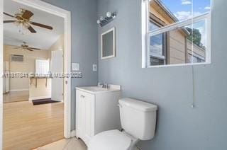 1416 N 2nd Ave N, Lake Worth, FL 33460 - bathroom featuring toilet, a ceiling fan, vanity, wood finished floors, and baseboards