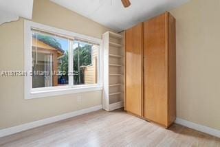 1416 N 2nd Ave N, Lake Worth, FL 33460 - unfurnished bedroom with baseboards, wood finished floors, and a ceiling fan