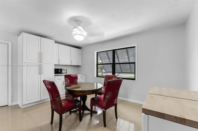 16040 SW 287th St, Homestead, FL 33033 - dining area featuring light tile patterned floors and baseboards