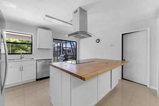 16040 SW 287th St, Homestead, FL 33033 - kitchen featuring appliances with stainless steel finishes, island range hood, wooden counters, a sink, and white cabinetry