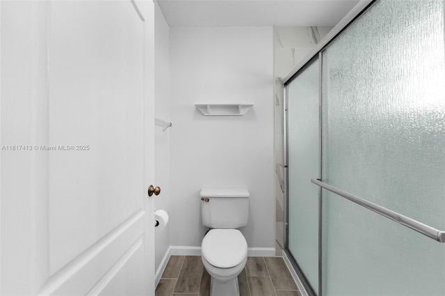 16040 SW 287th St, Homestead, FL 33033 - bathroom with toilet, a stall shower, wood finish floors, and baseboards