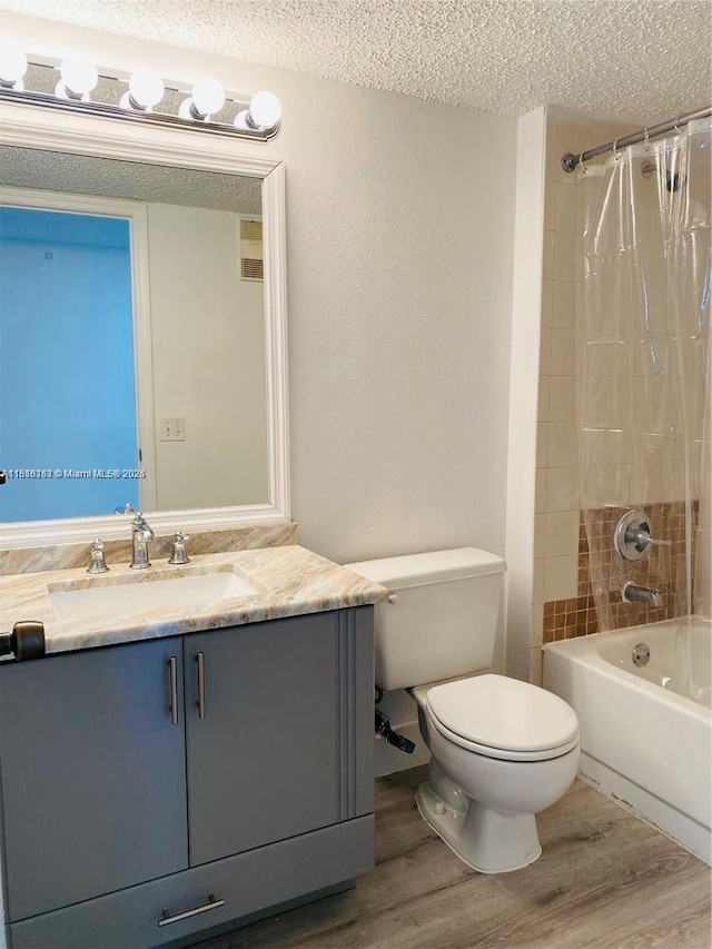 4015 W Mcnab Rd Unit D203, Pompano Beach, FL 33069 - full bath with wood finished floors, a textured ceiling, toilet, vanity, and shower / tub combo with curtain