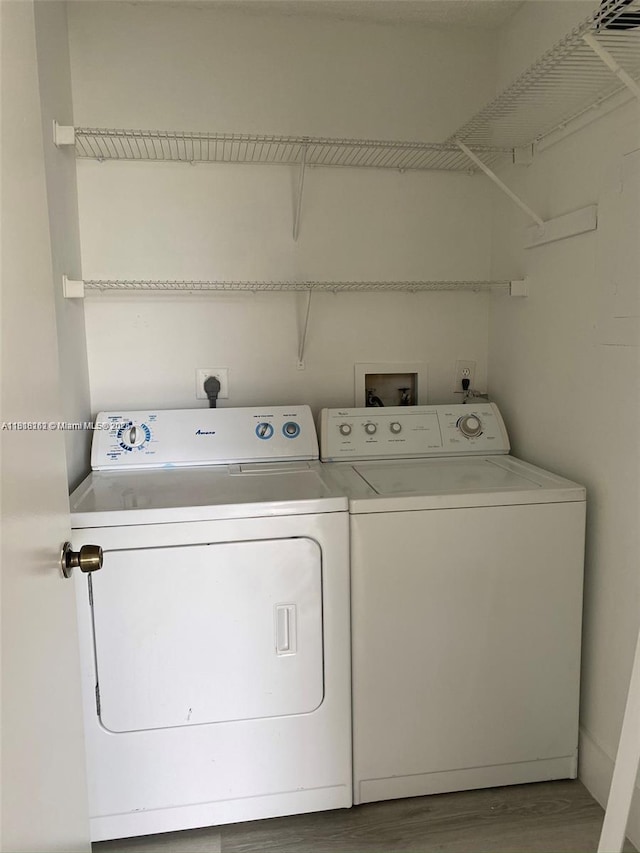 4015 W Mcnab Rd Unit D203, Pompano Beach, FL 33069 - laundry room featuring separate washer and dryer and wood finished floors