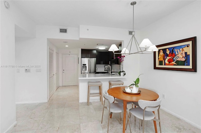 10 Aragon Ave Unit 919, Coral Gables, FL 33134 - dining area with baseboards and a chandelier