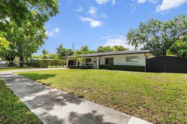 6301 Lake Geneva Rd, Miami Lakes, FL 33014 - ranch-style house with driveway, stucco siding, metal roof, and a gate
