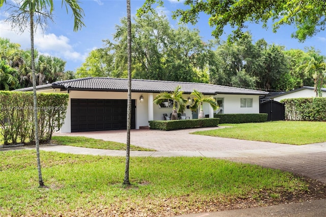 6301 Lake Geneva Rd, Miami Lakes, FL 33014 - view of front of property featuring driveway, stucco siding, a front yard, an attached garage, and a tile roof