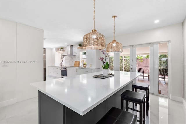 6301 Lake Geneva Rd, Miami Lakes, FL 33014 - kitchen featuring wall chimney range hood, a sink, white cabinets, oven, and light countertops