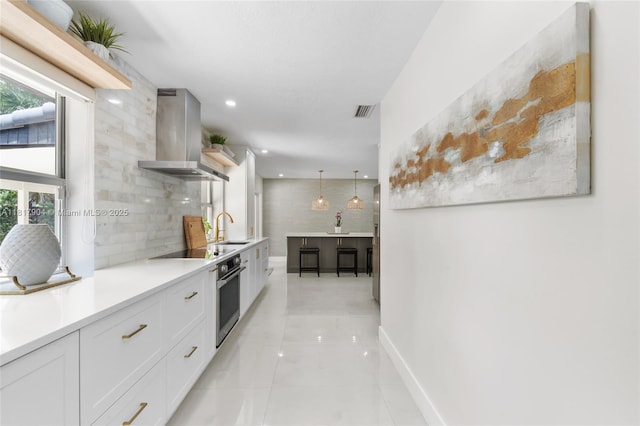 6301 Lake Geneva Rd, Miami Lakes, FL 33014 - kitchen with island exhaust hood, a sink, stainless steel oven, open shelves, and white cabinets