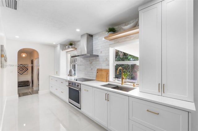 6301 Lake Geneva Rd, Miami Lakes, FL 33014 - kitchen with wall chimney range hood, stainless steel oven, a sink, open shelves, and arched walkways
