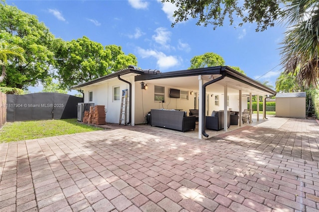 6301 Lake Geneva Rd, Miami Lakes, FL 33014 - rear view of house featuring an outdoor living space, stucco siding, a patio area, and cooling unit