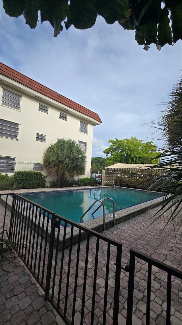 13655 NE 10th Ave Unit 108, North Miami, FL 33161 - view of swimming pool featuring a patio