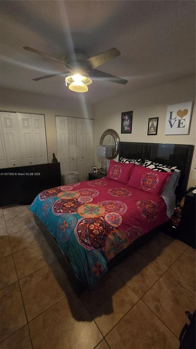 13655 NE 10th Ave Unit 108, North Miami, FL 33161 - tiled bedroom featuring multiple closets and ceiling fan