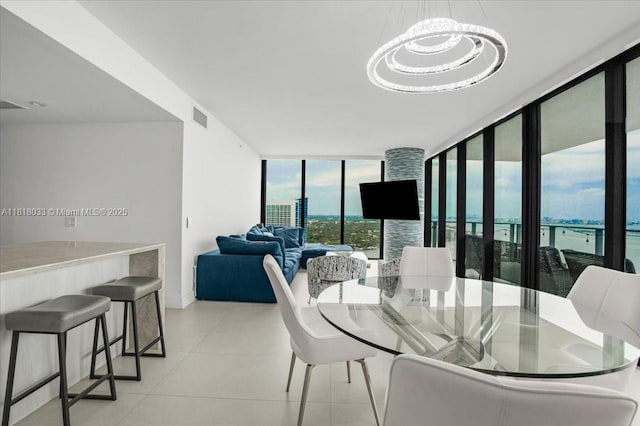 3131 NE 7th Ave Unit 3306, Miami, FL 33137 - dining area featuring expansive windows, light tile patterned floors, baseboards, and a chandelier