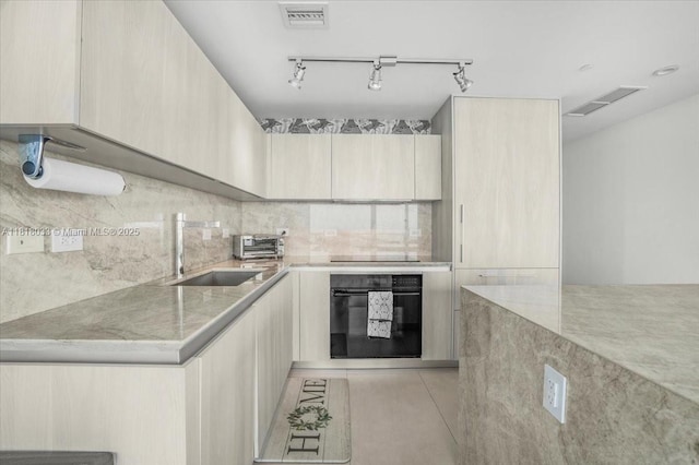3131 NE 7th Ave Unit 3306, Miami, FL 33137 - kitchen with black appliances, a sink, modern cabinets, decorative backsplash, and light brown cabinets