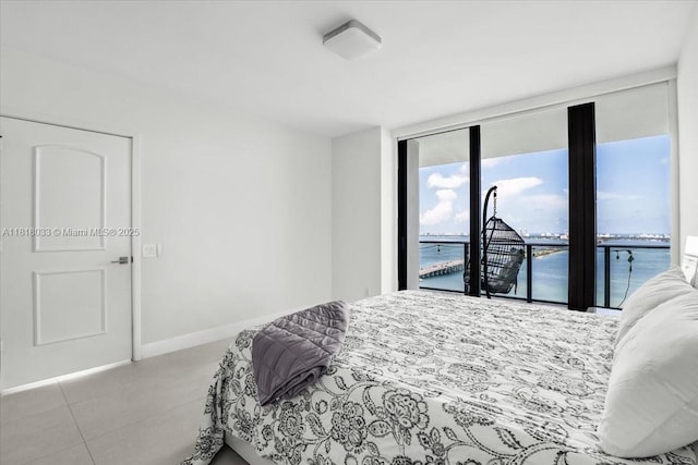 3131 NE 7th Ave Unit 3306, Miami, FL 33137 - bedroom featuring access to exterior, a water view, a wall of windows, and baseboards