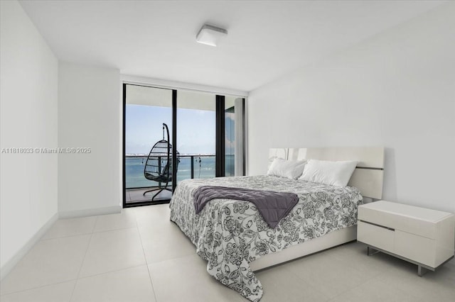 3131 NE 7th Ave Unit 3306, Miami, FL 33137 - bedroom with access to outside, baseboards, light tile patterned flooring, and a wall of windows